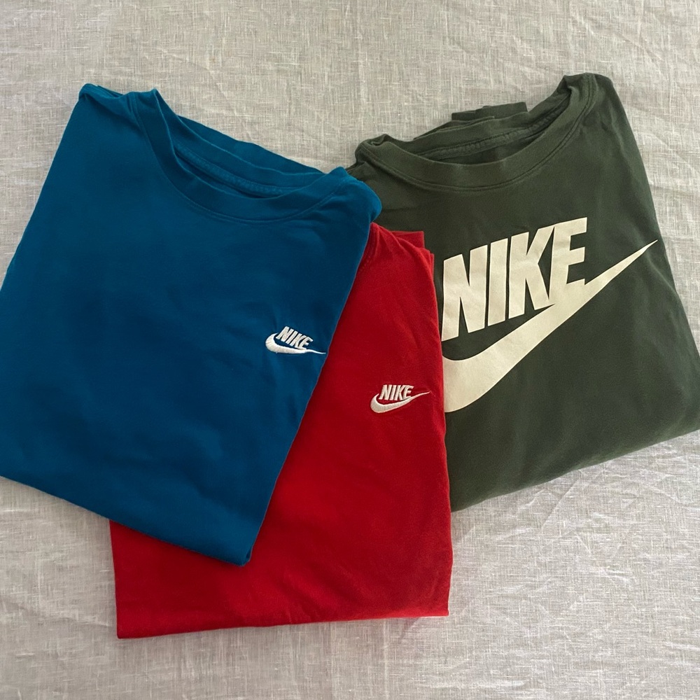 Three men’s small Nike t-shirts-1 long-sleeved and 2 short-sleeved.